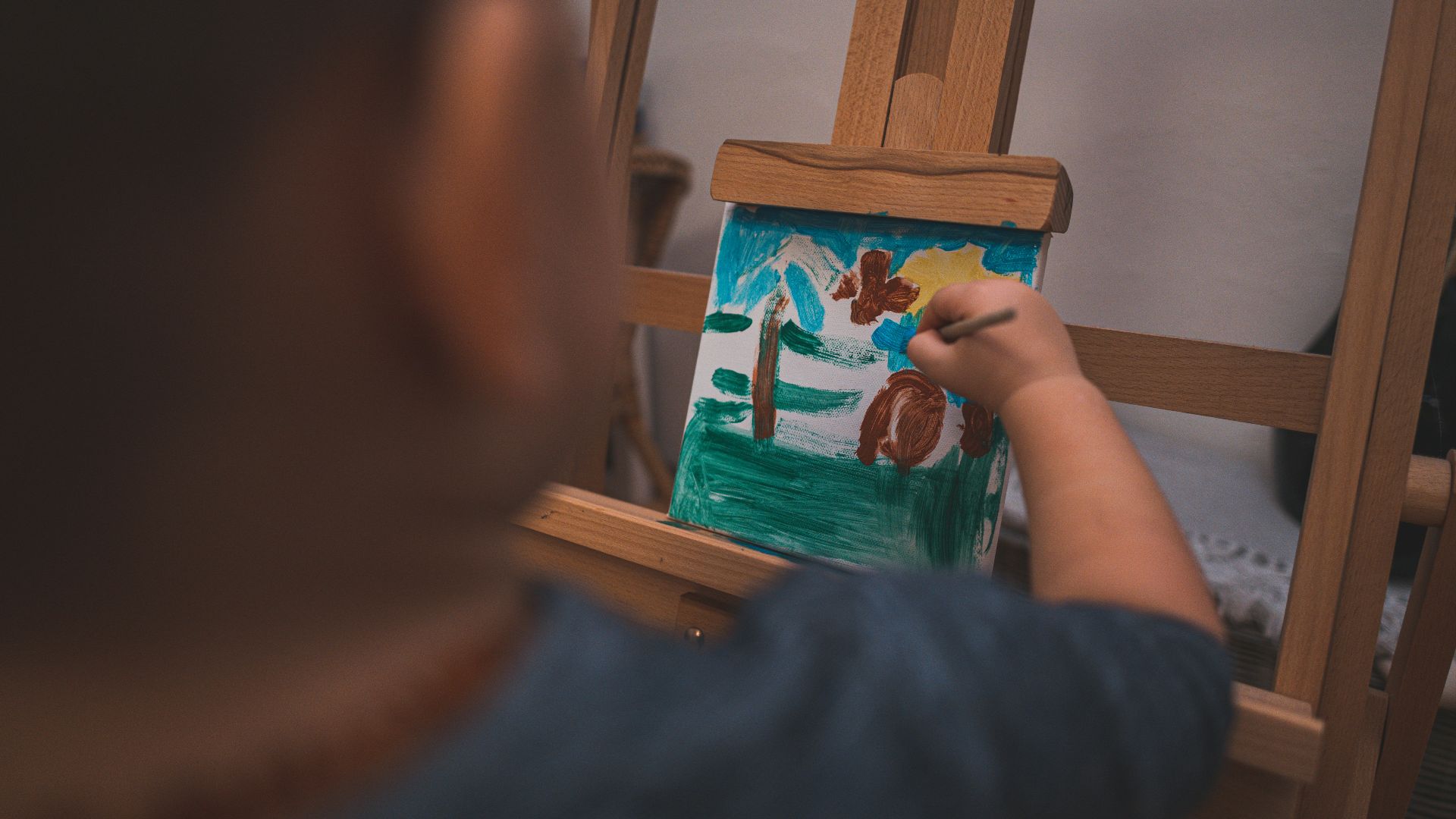 person holding green and blue house print card