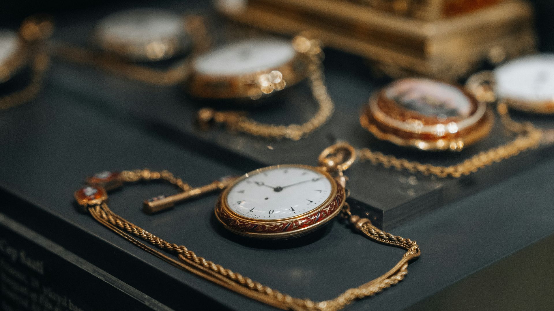 a collection of antique pocket watches on display