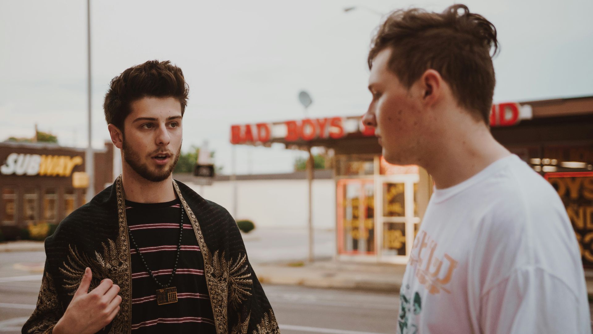 man talking to another man