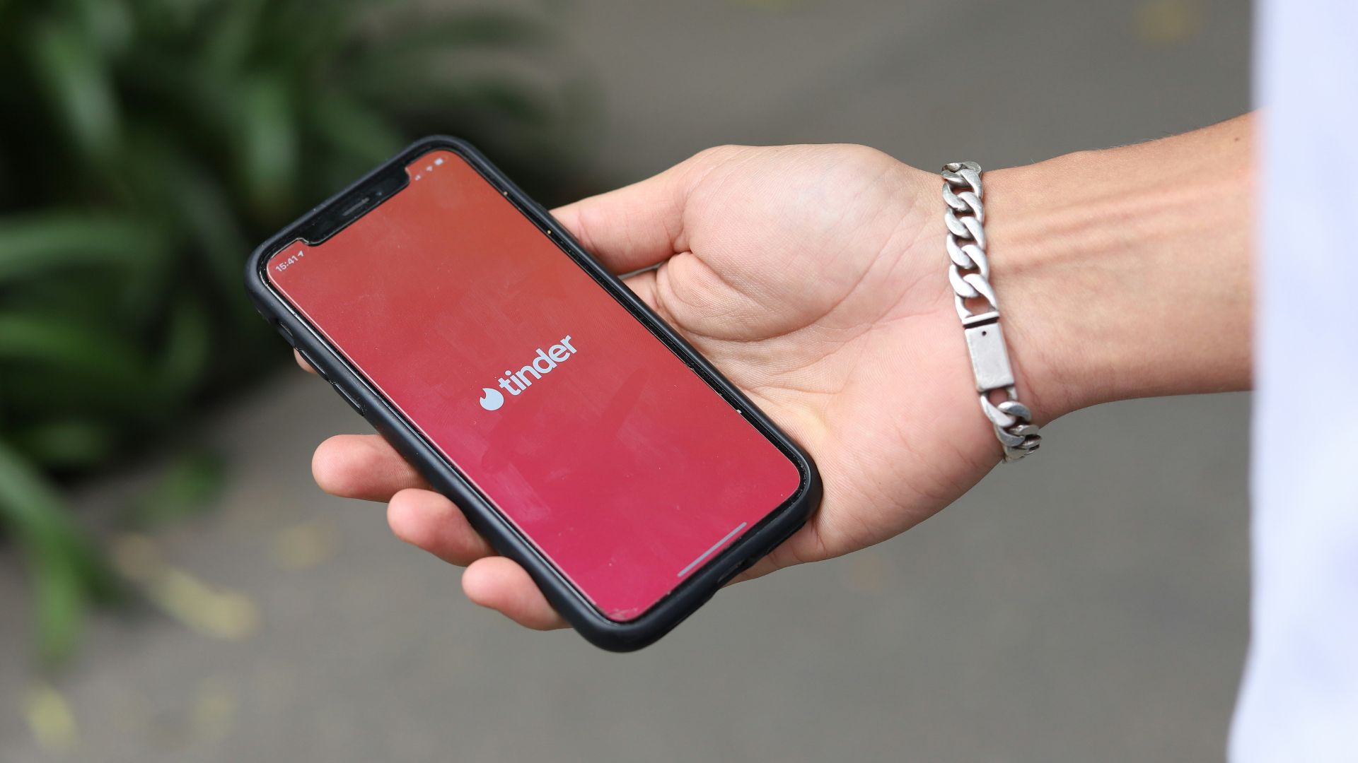 a person holding a red cell phone in their hand