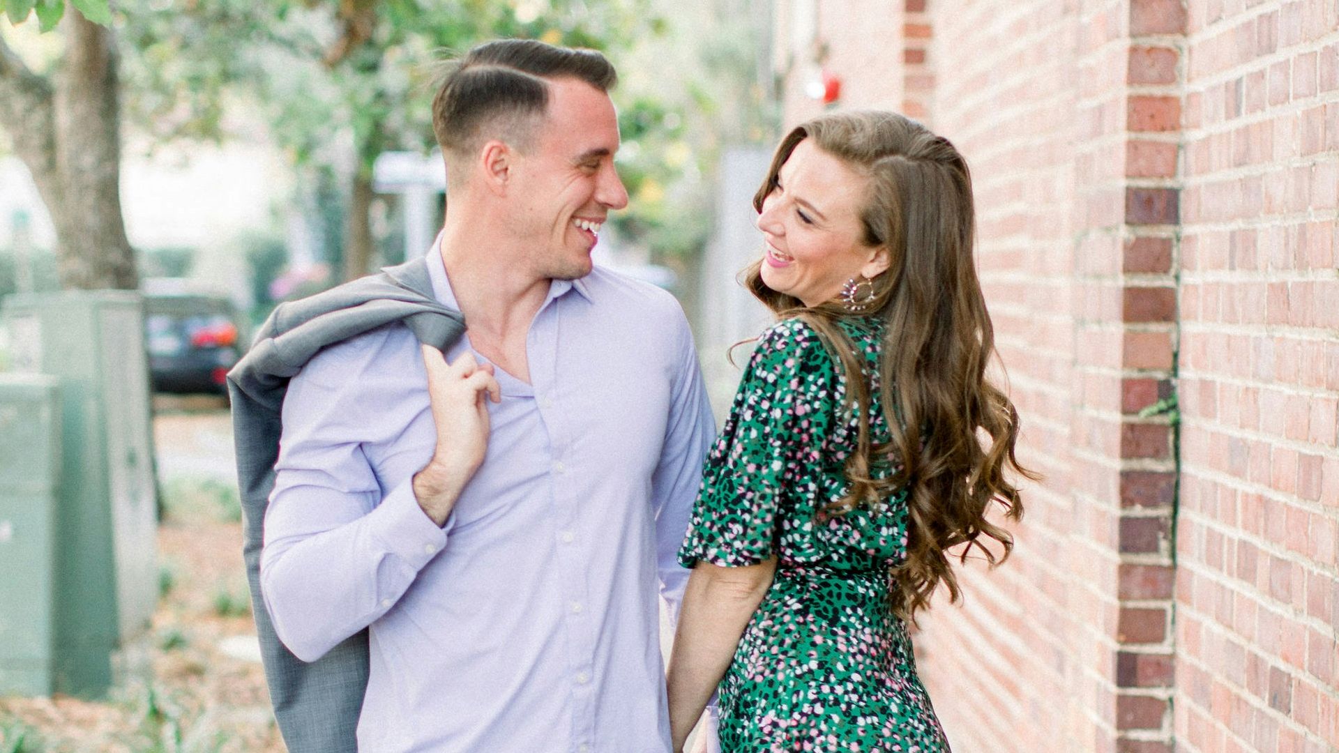 woman in white long sleeve shirt standing beside woman in green and white floral dress
