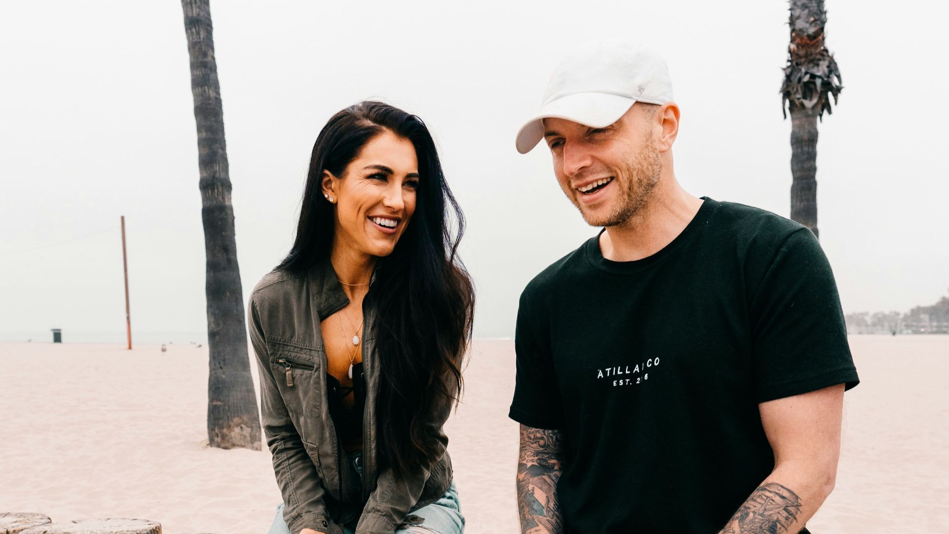 woman in white cap, black t-shirt, and black jeans