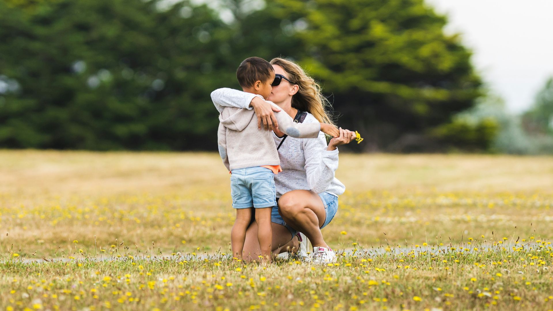a couple of people that are standing in the grass