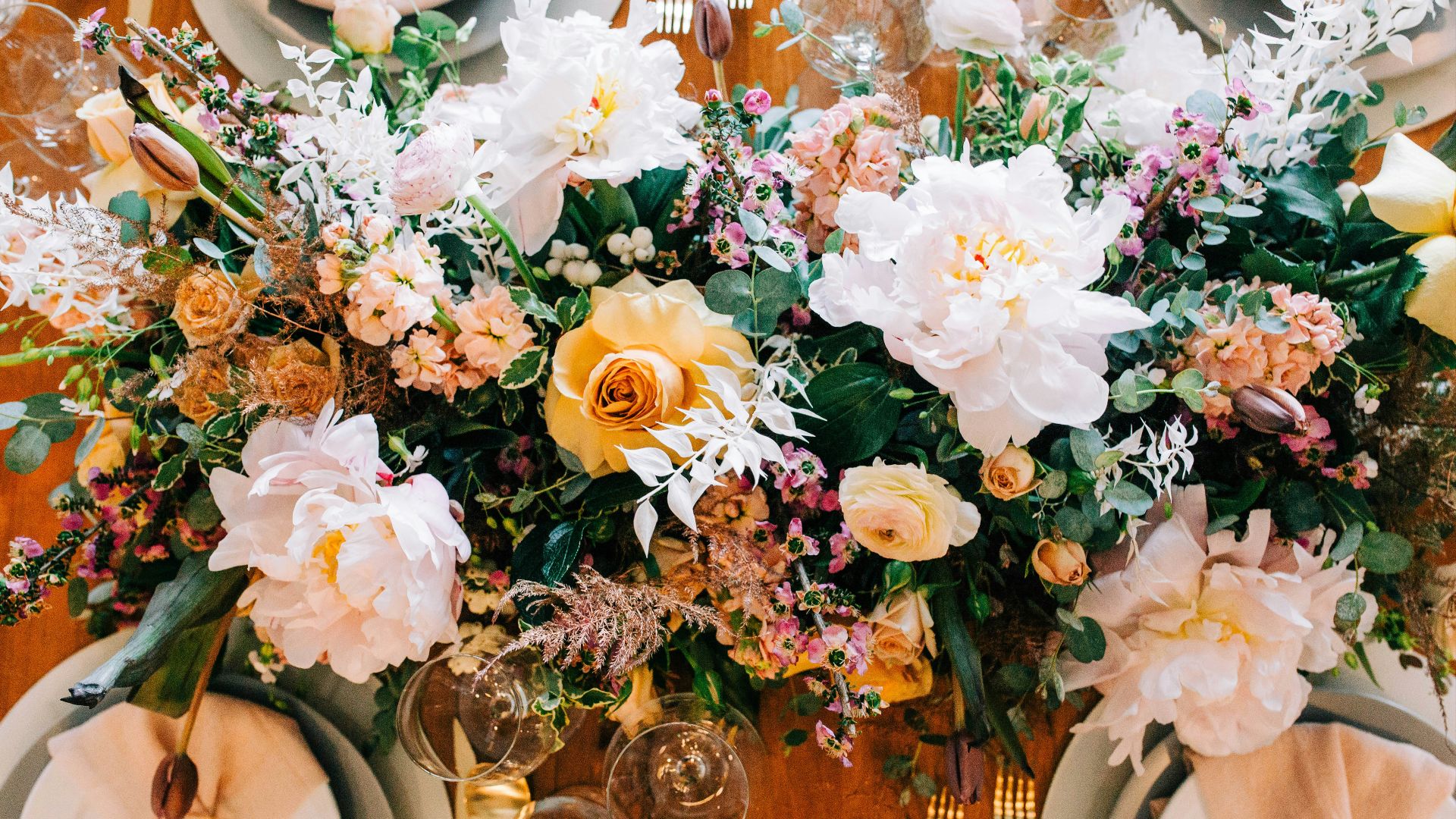 a close up of a table with plates and flowers