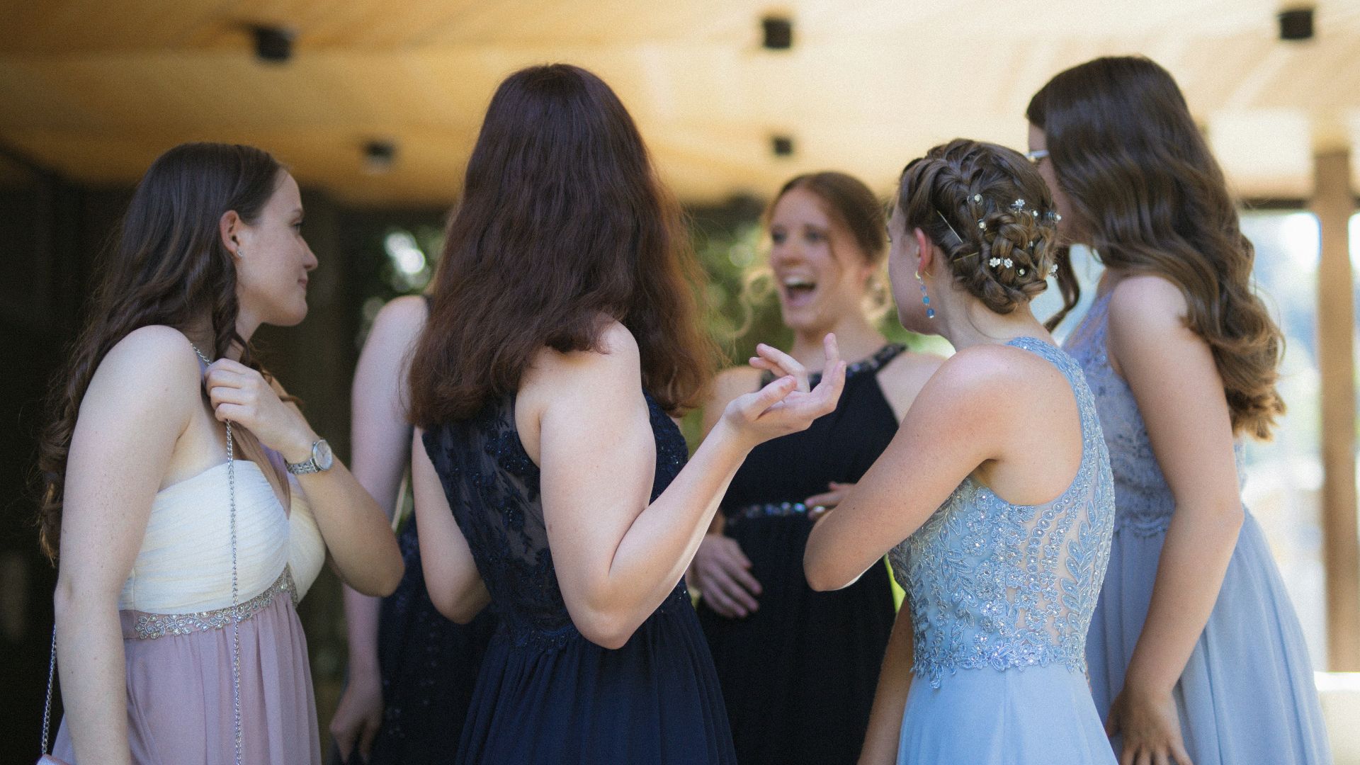 woman in black dress standing in front of woman in white dress