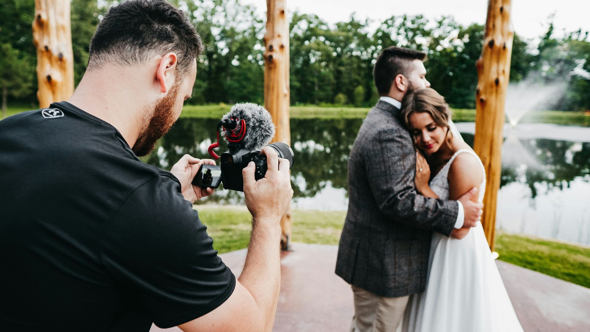 man in black t-shirt holding black dslr camera
