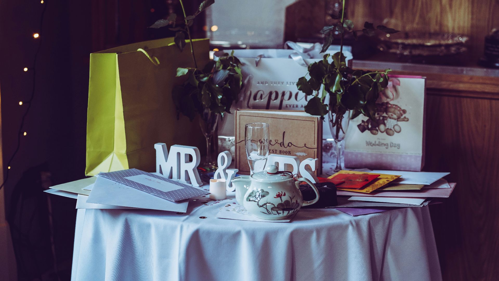 two red roses and mr. & mrs. free-standing letters on top of table