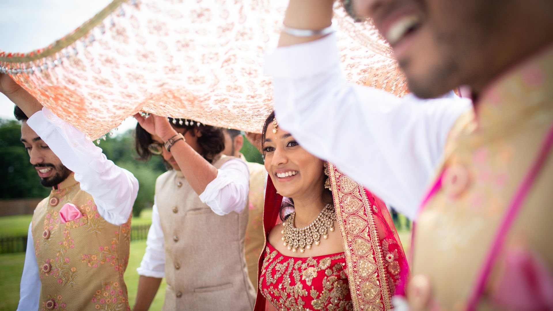 shallow focus photo of woman in red sari dress