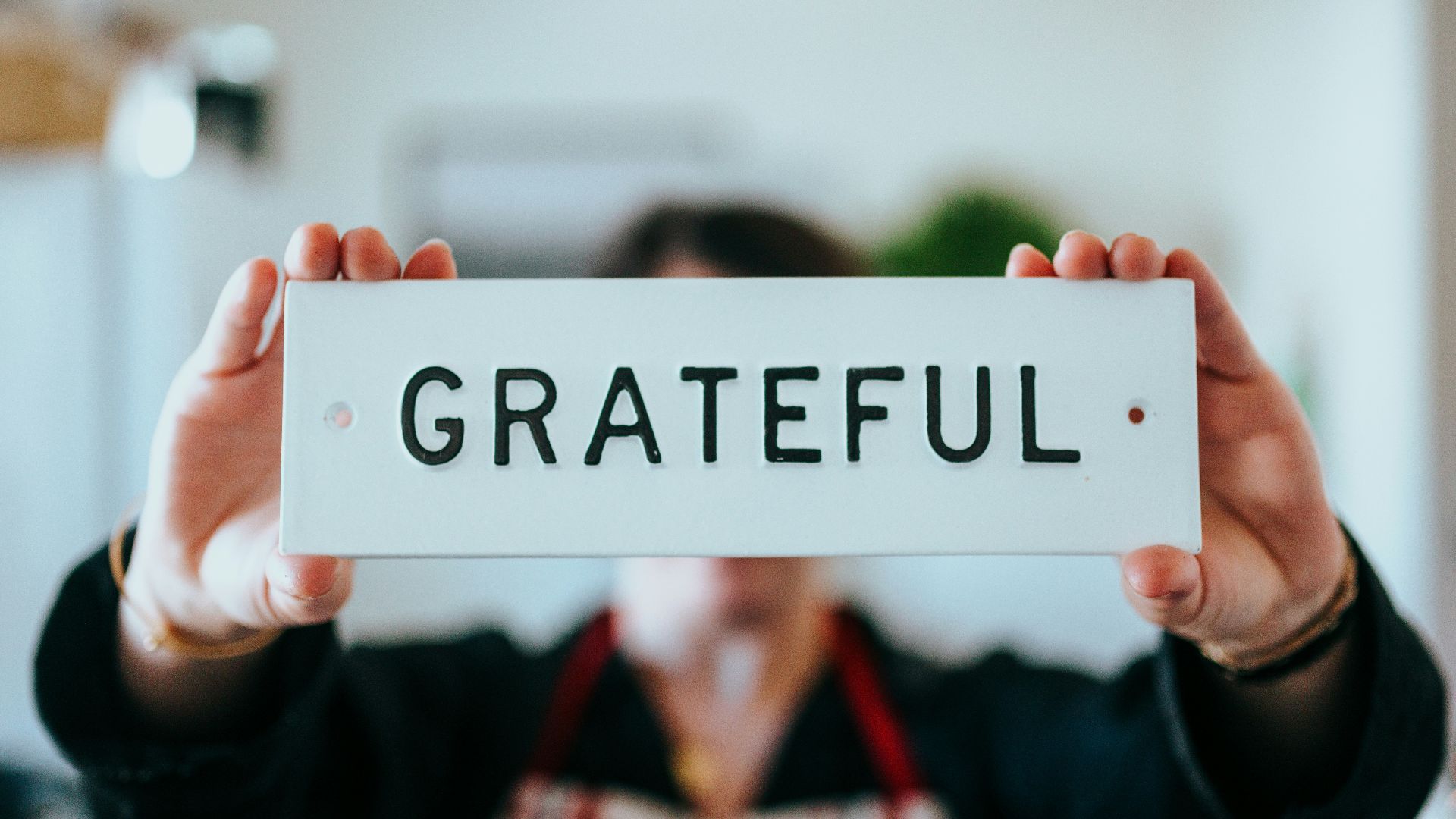 person holding white and black i love you print card