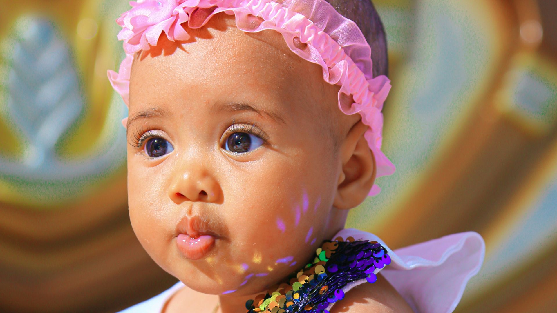 a baby with a pink headband