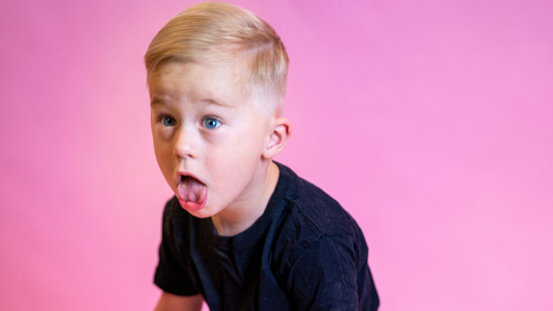 boy in blue crew neck t-shirt and brown shorts holding black and gray stick