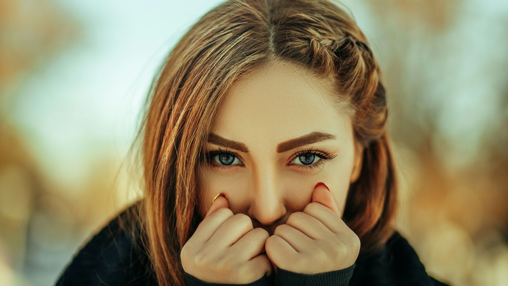 a woman covering her face with her hands