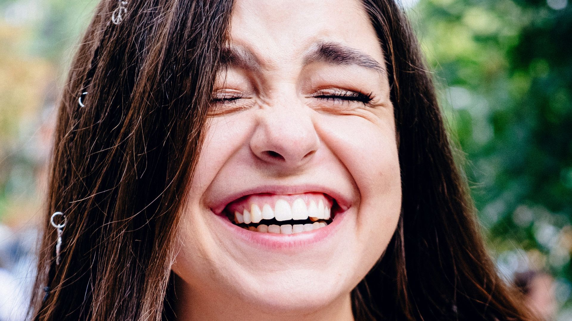 woman in black spaghetti strap top smiling
