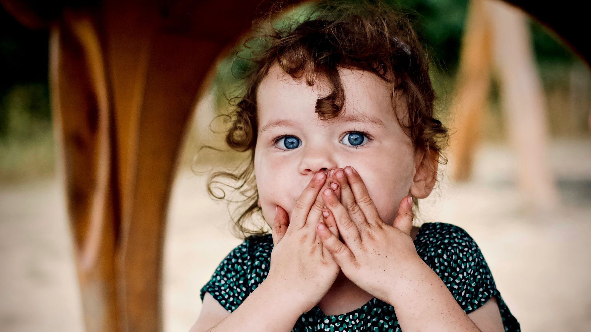 toddler holding her lips