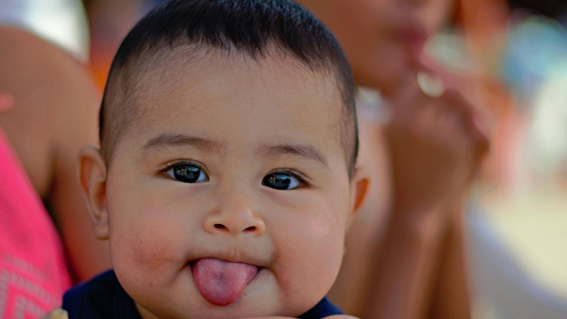 boy in red shirt lying on white table