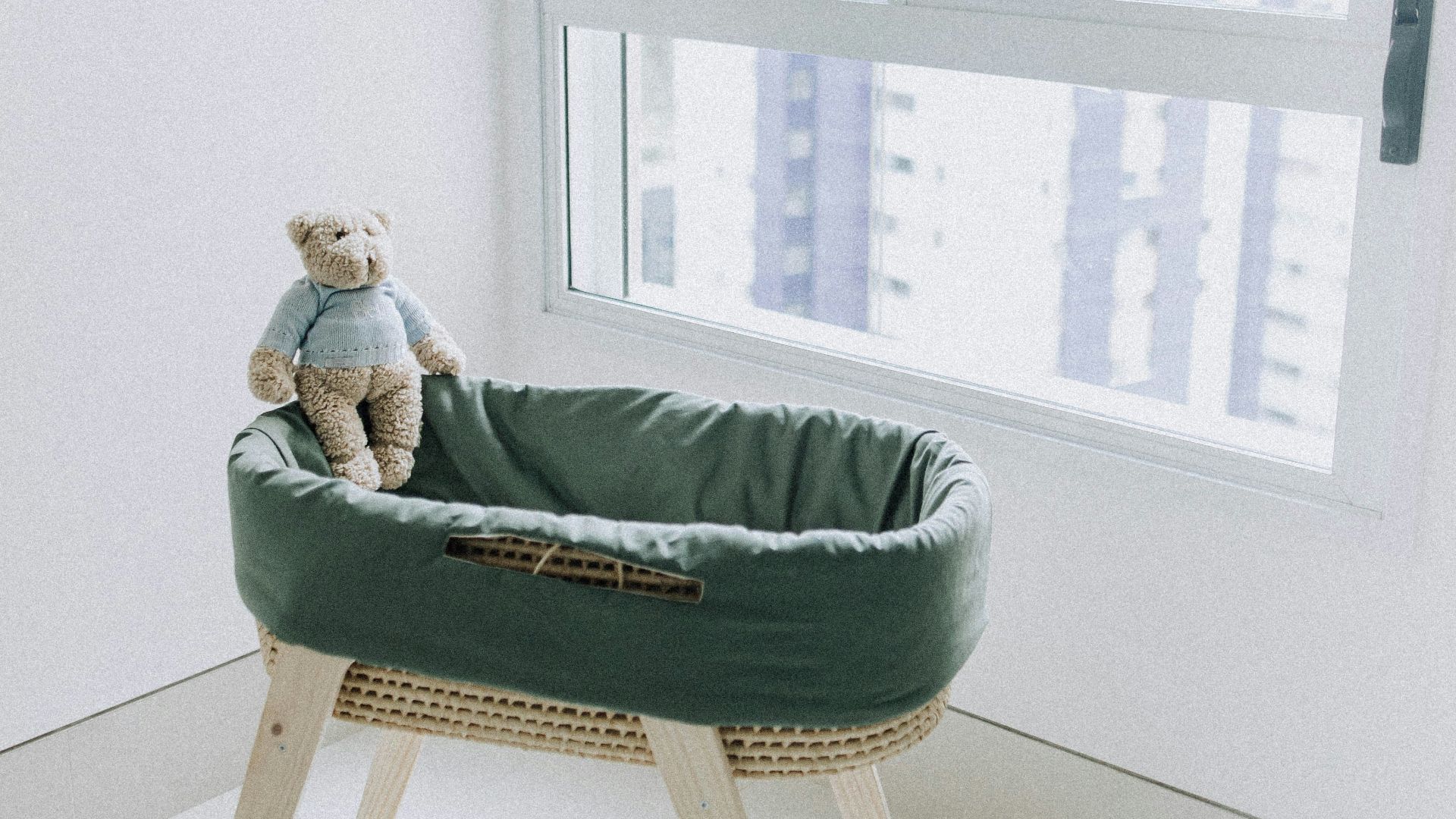 woman in green sweater lying on bed