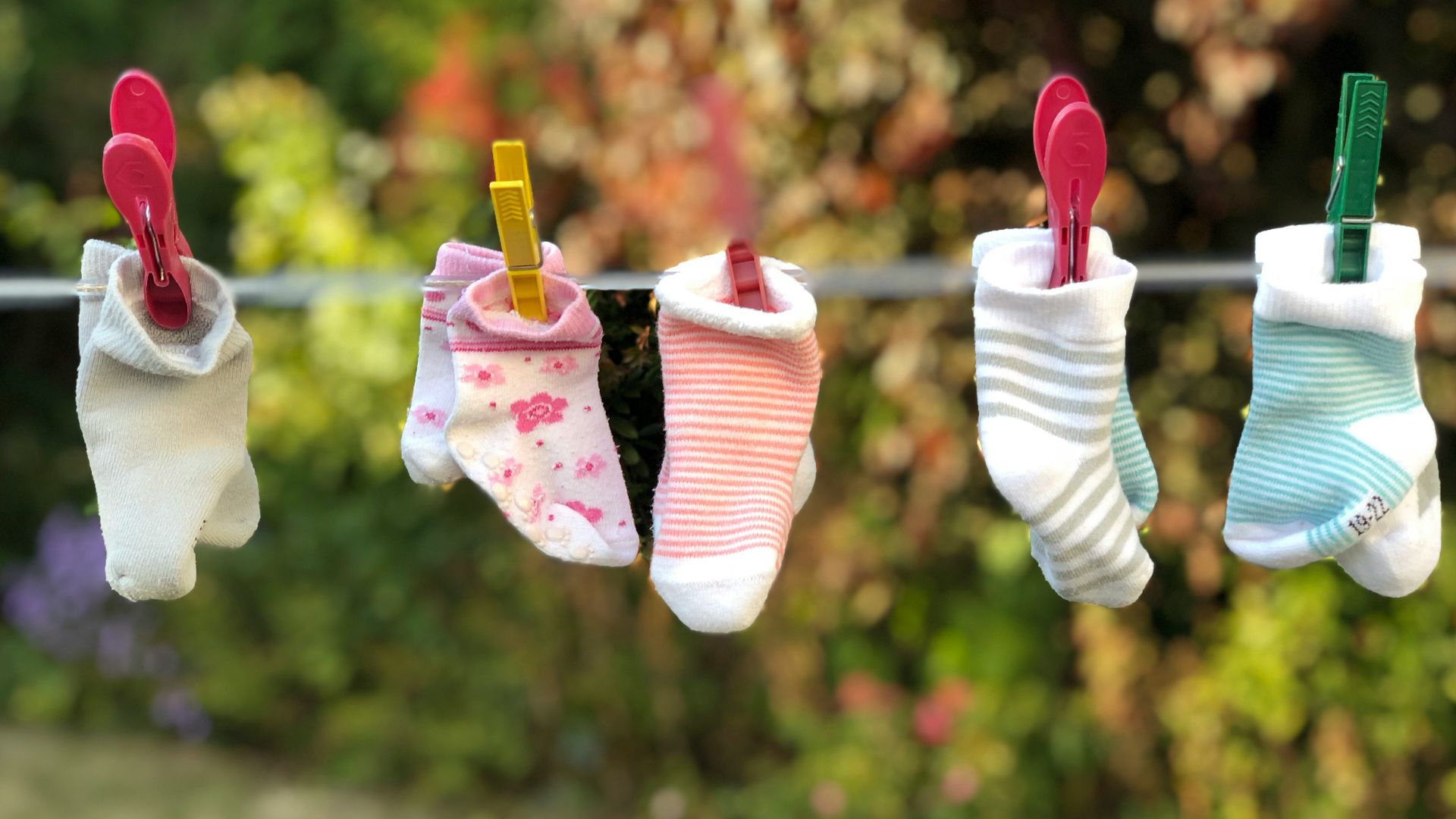 five pairs of socks pinned on clothesline
