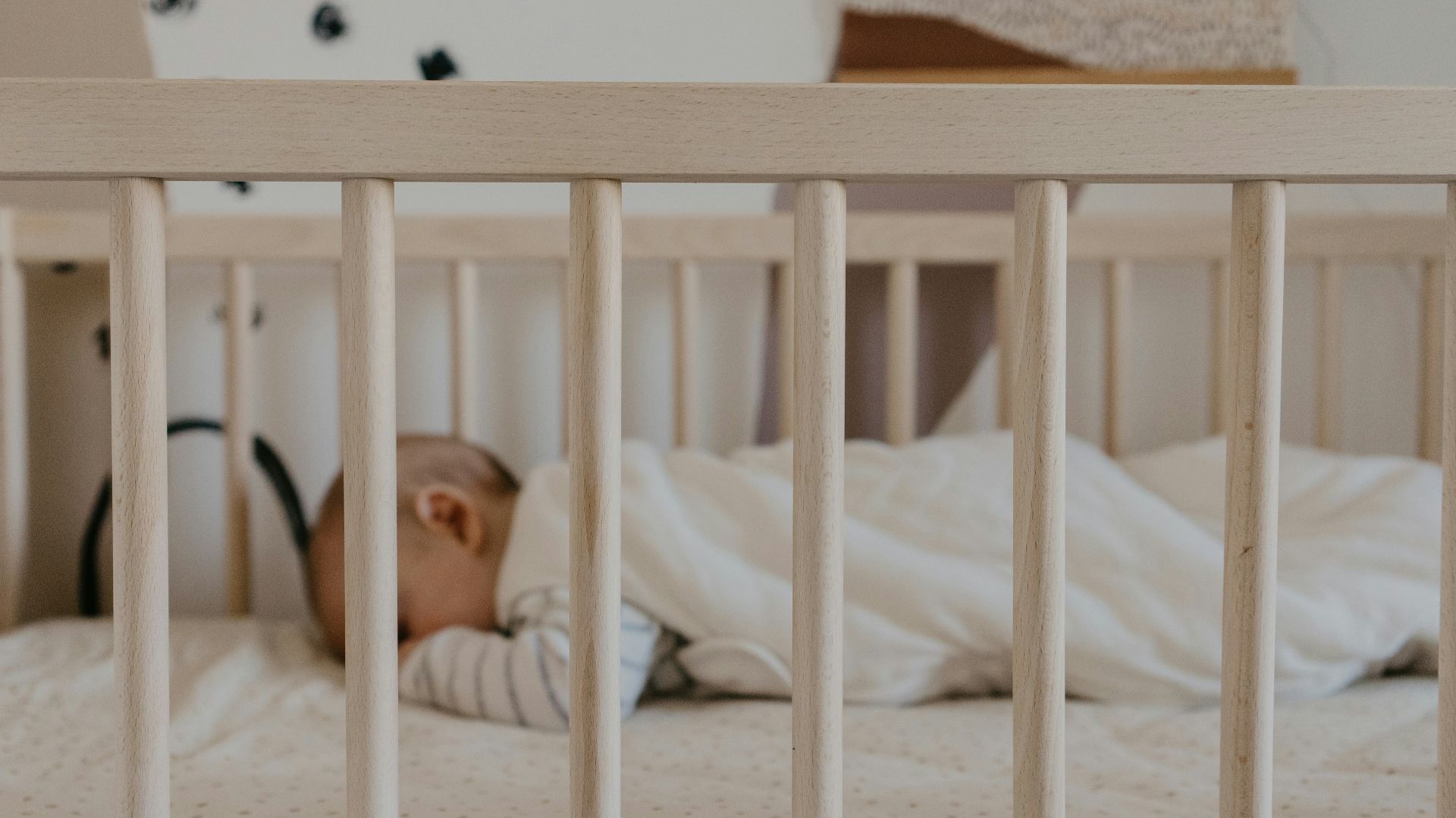 a person sleeping in a crib