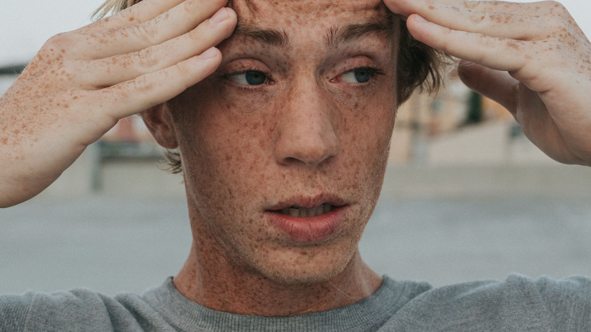 man in gray crew neck shirt with brown hair