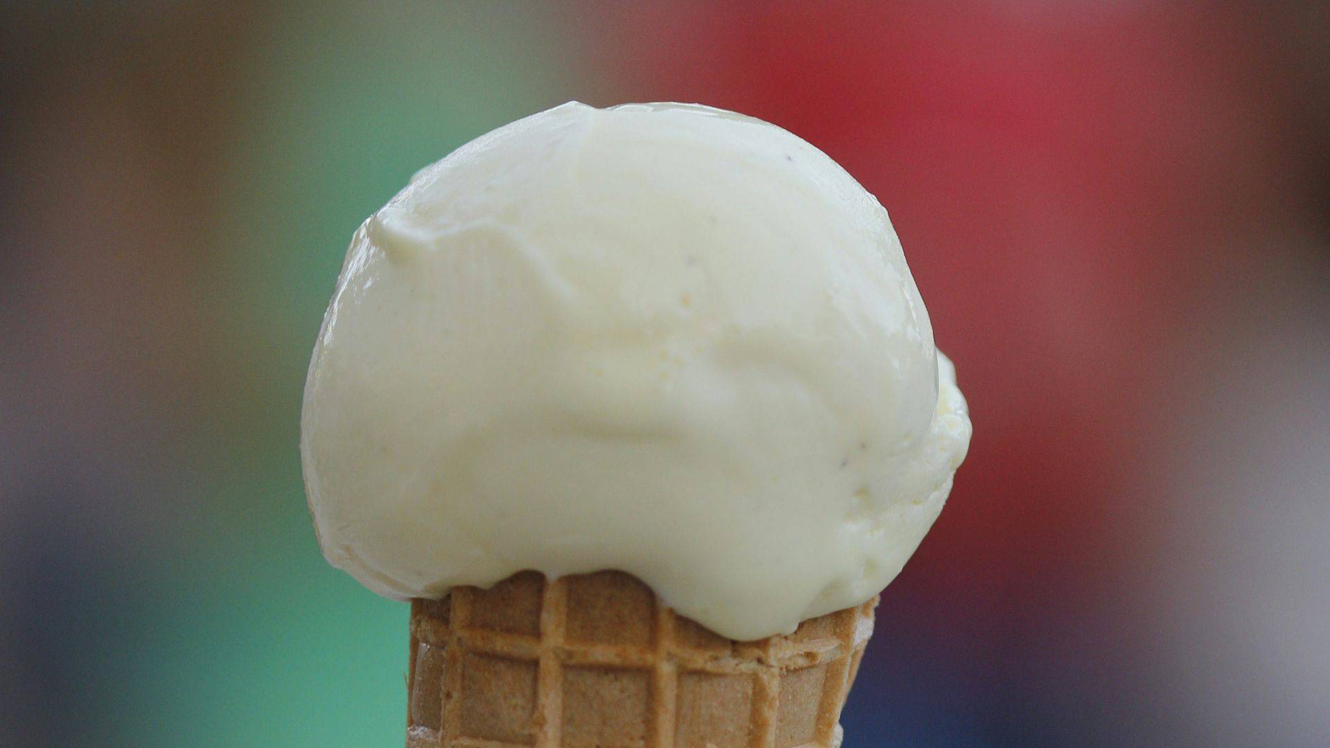 a hand holding a cone of ice cream