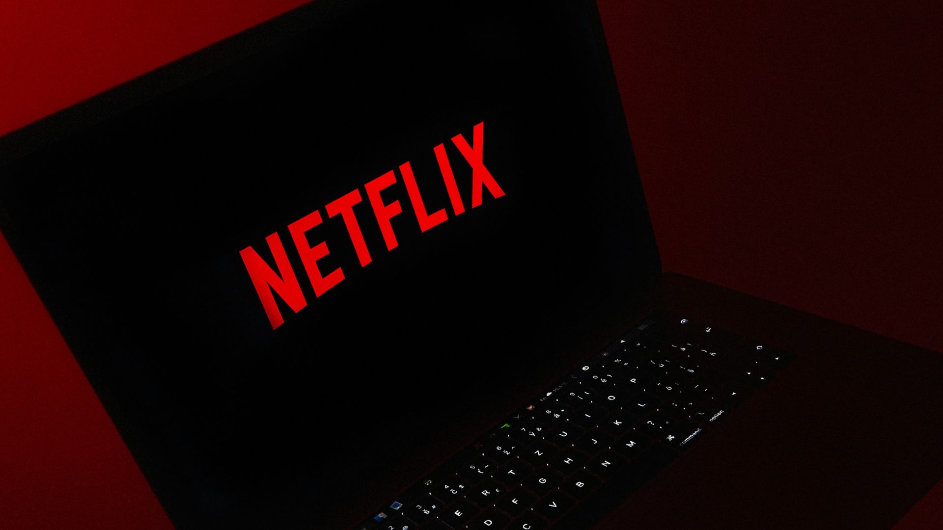 black laptop computer on red table