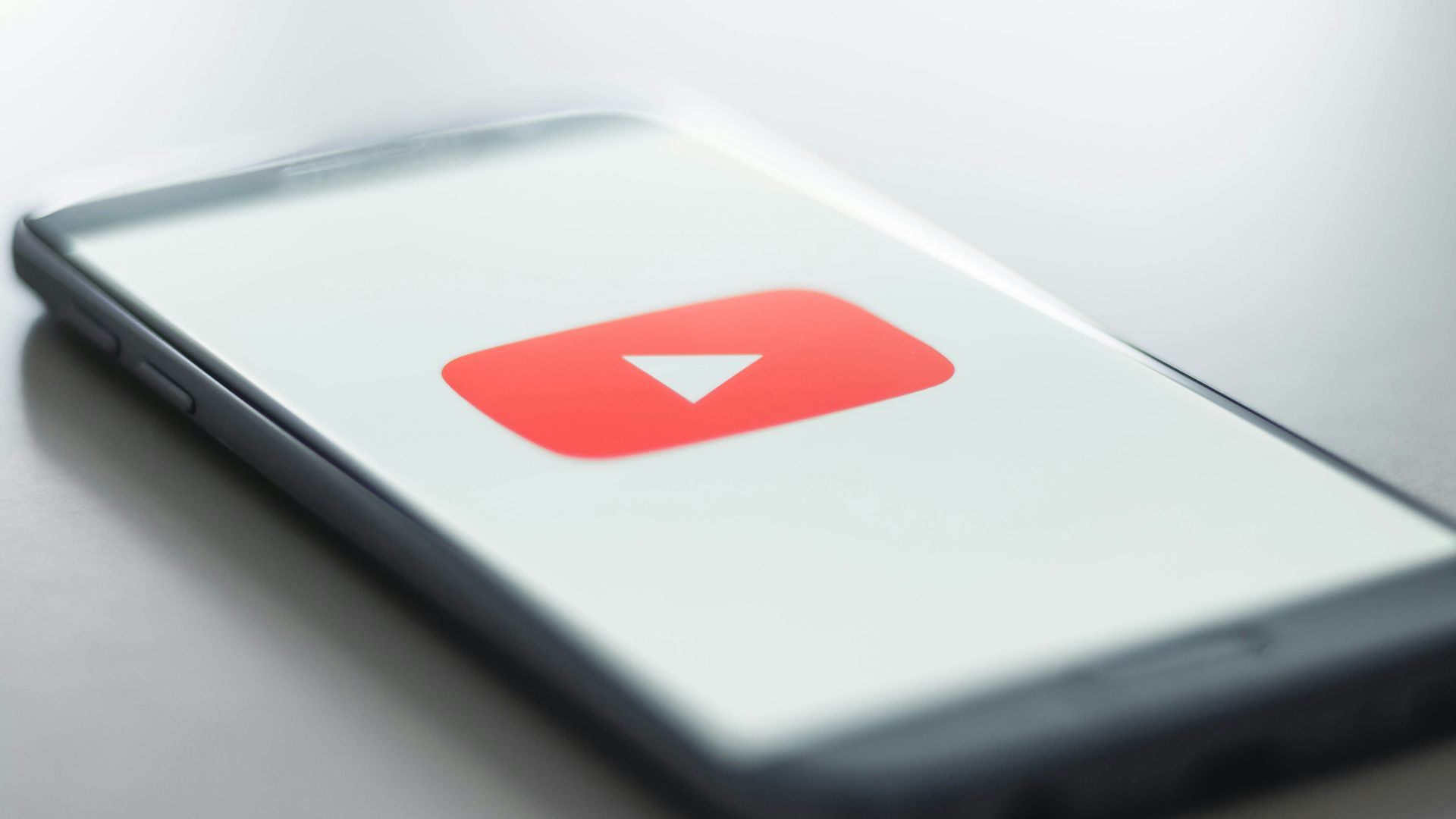 a close up of a cell phone with a youtube logo on it