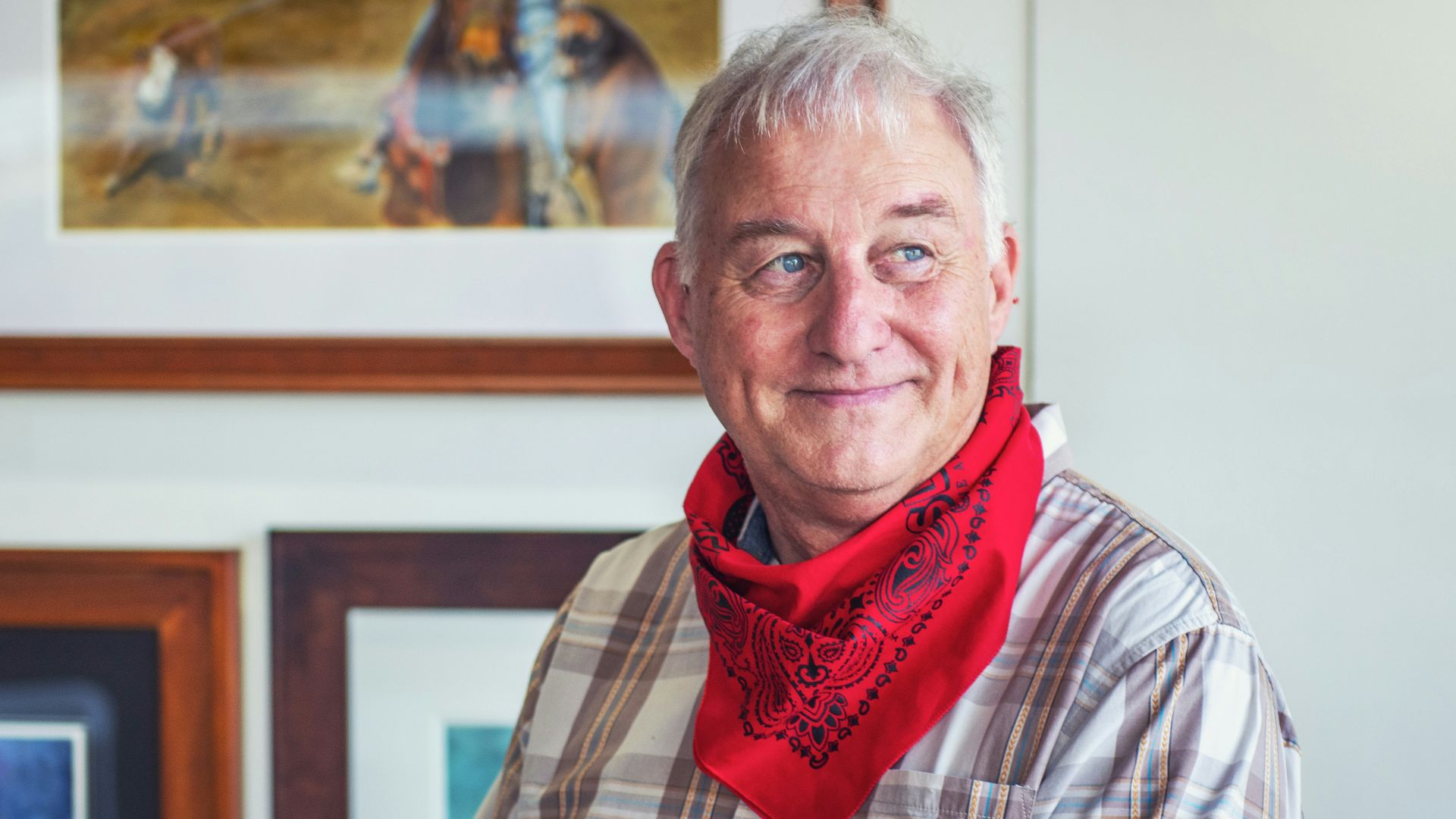 man in gray and white plaid dress shirt and red scarf