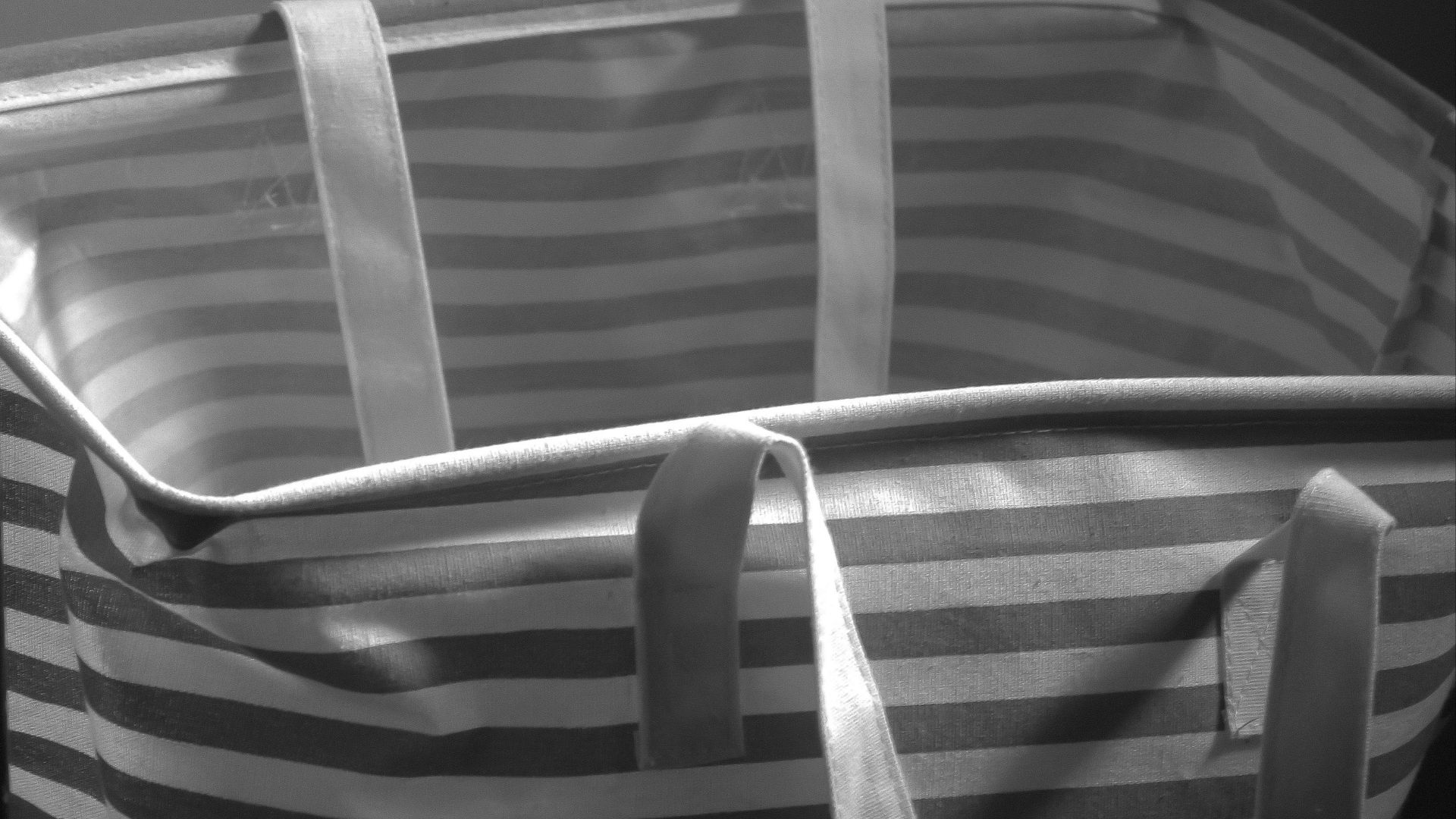 a striped bed with a white pillow