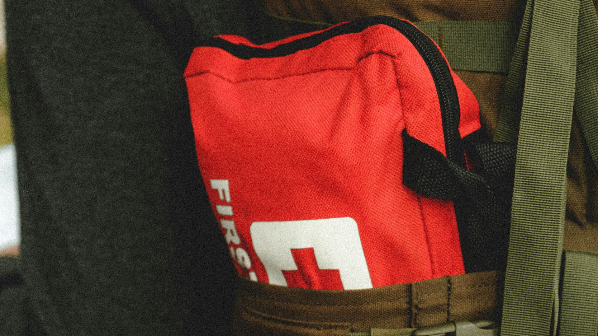 man in red and black shirt and brown pants with black backpack