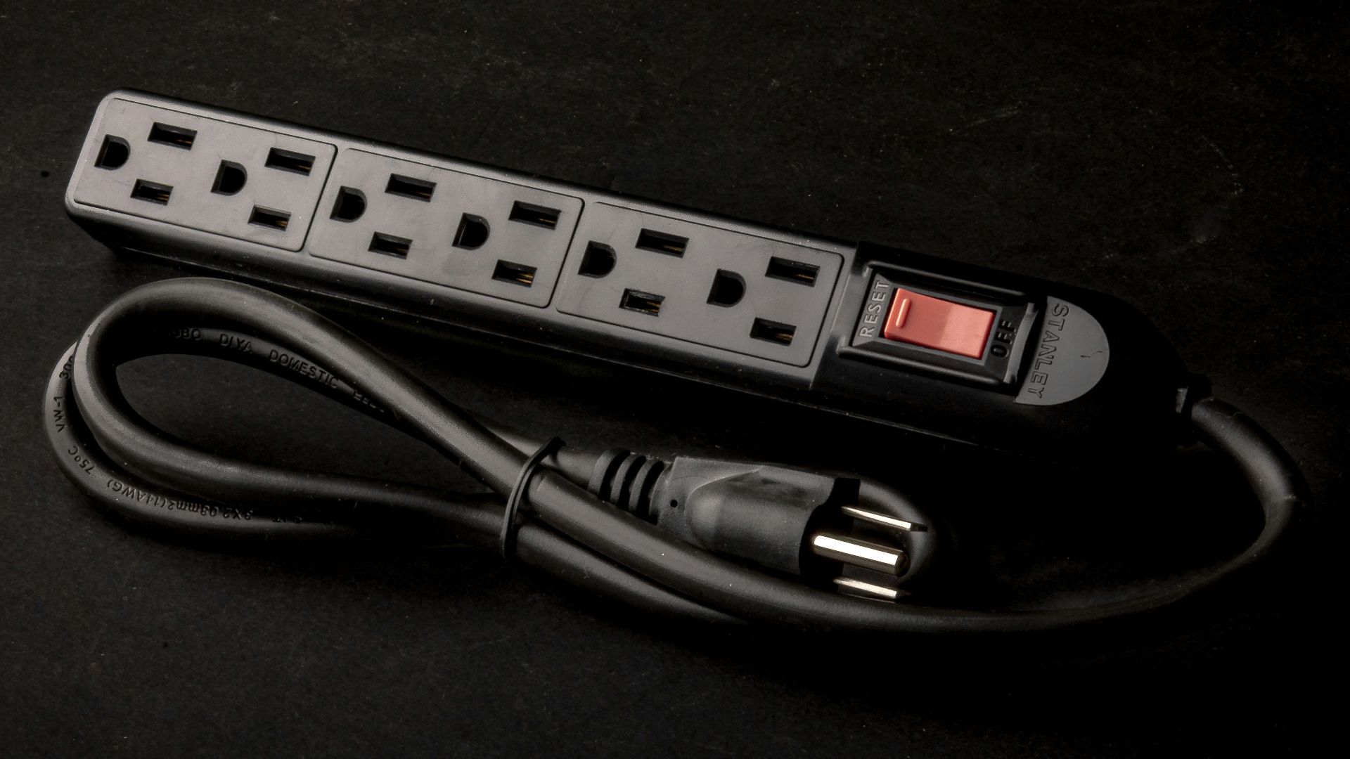 a black power strip sitting on top of a table