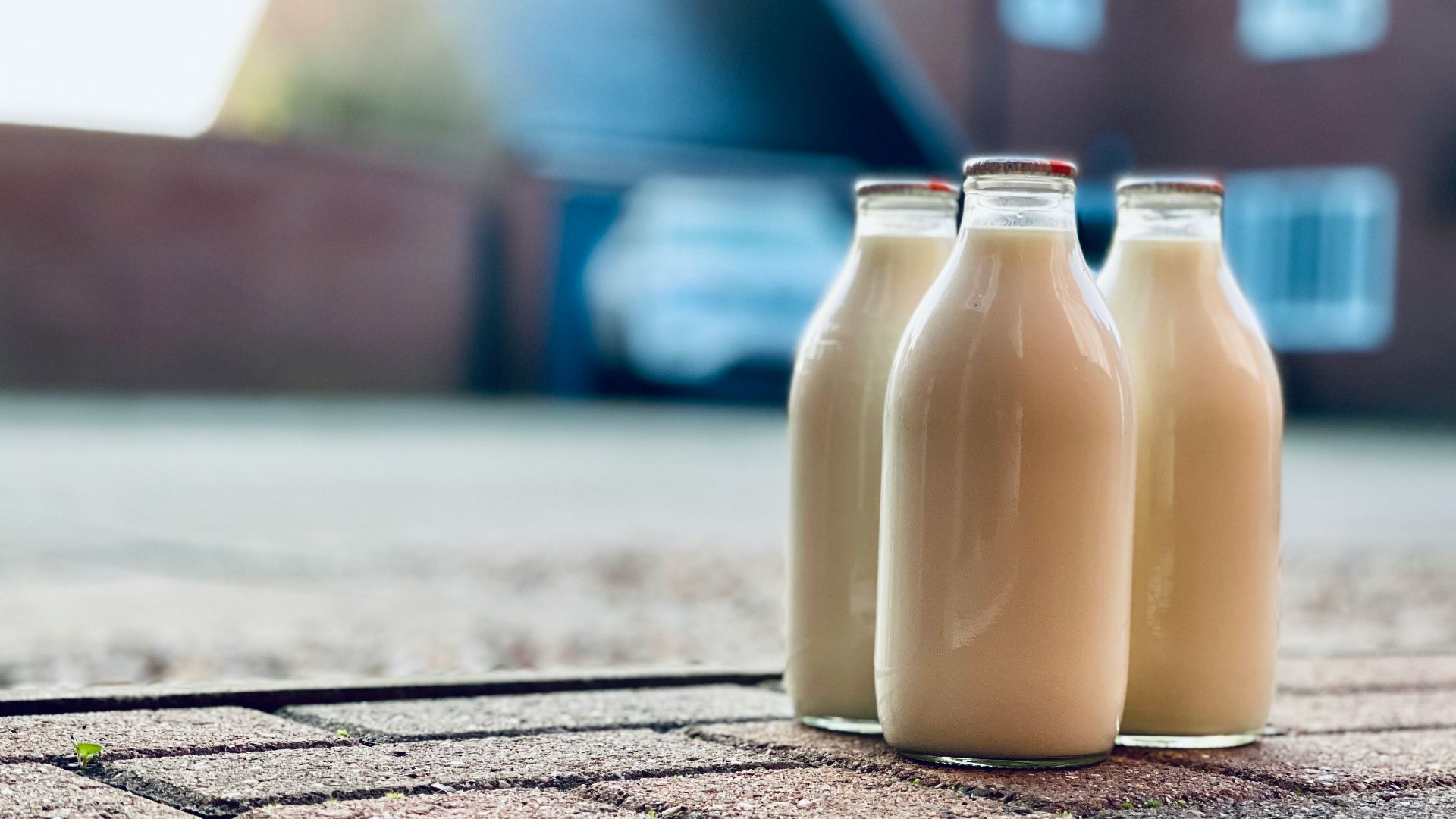 two white glass bottles on brown wooden table