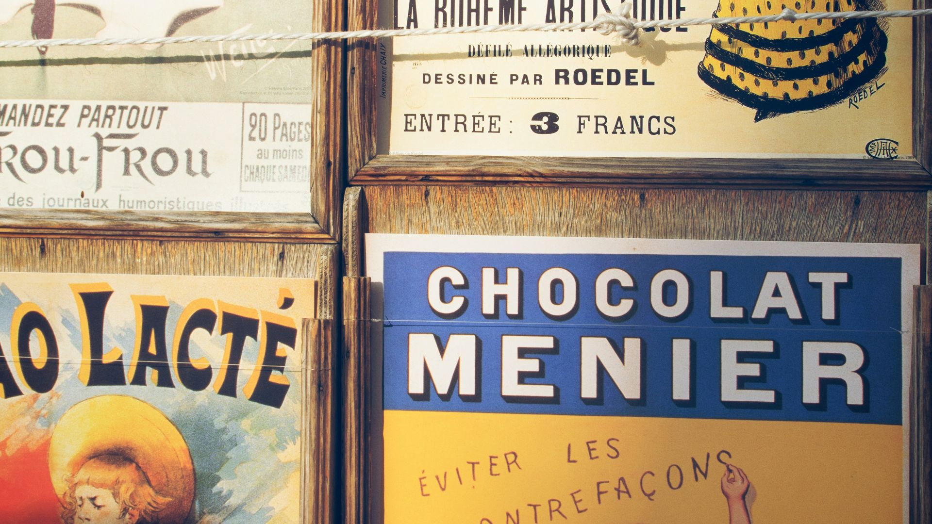 a bunch of posters on the wall of a building