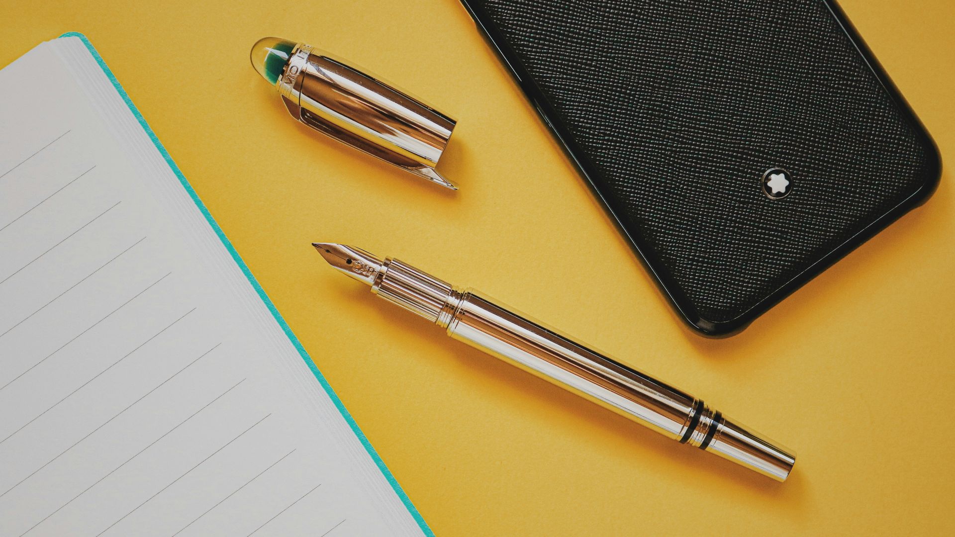 silver click pen on yellow paper