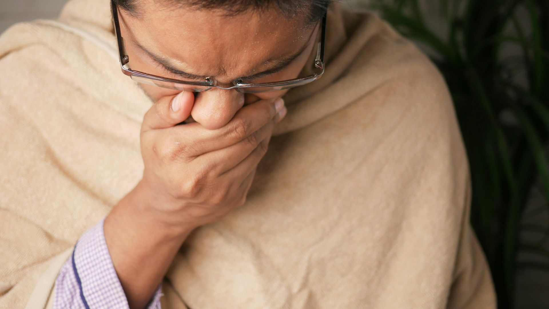 man in brown sweater wearing black framed eyeglasses