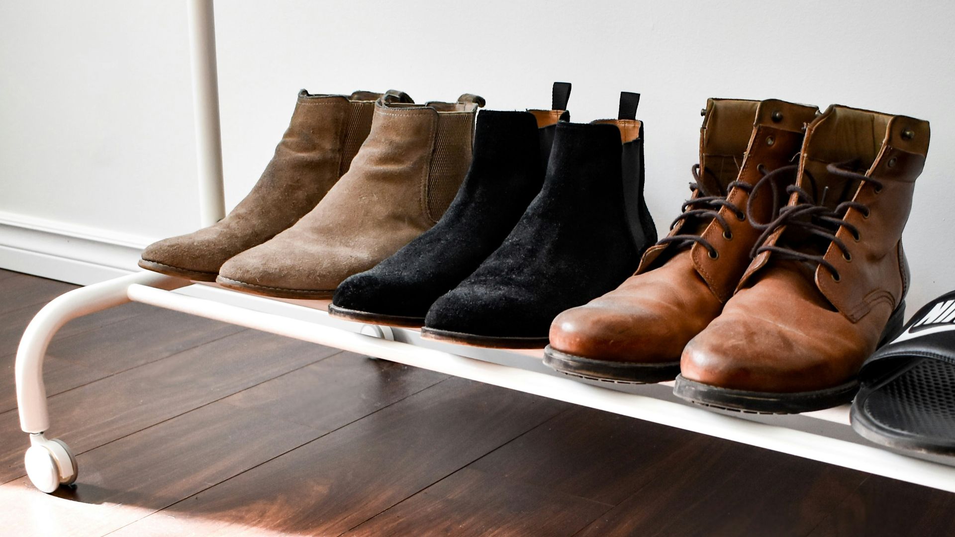 black and brown leather boots on brown wooden floor