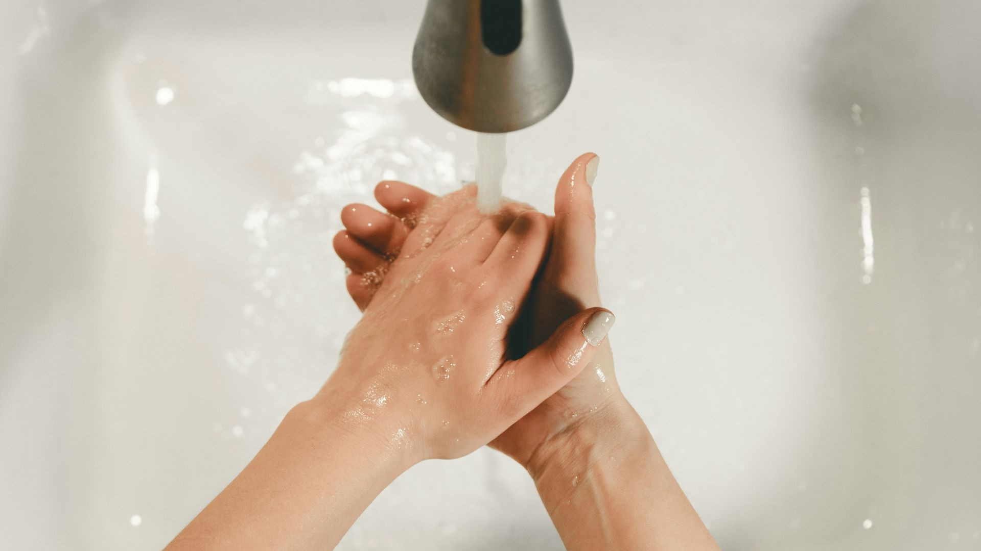 persons feet on white bathtub
