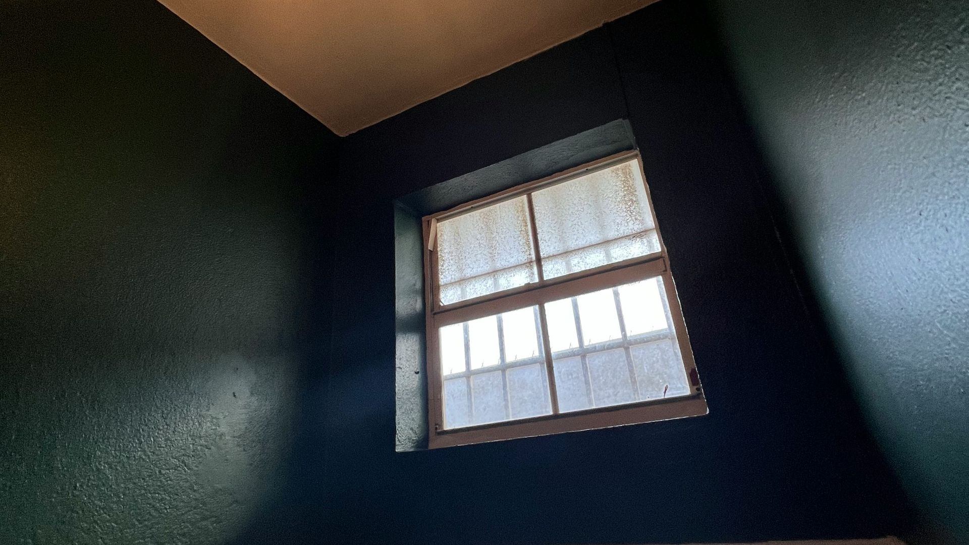 a bathroom with a window and tiled floor