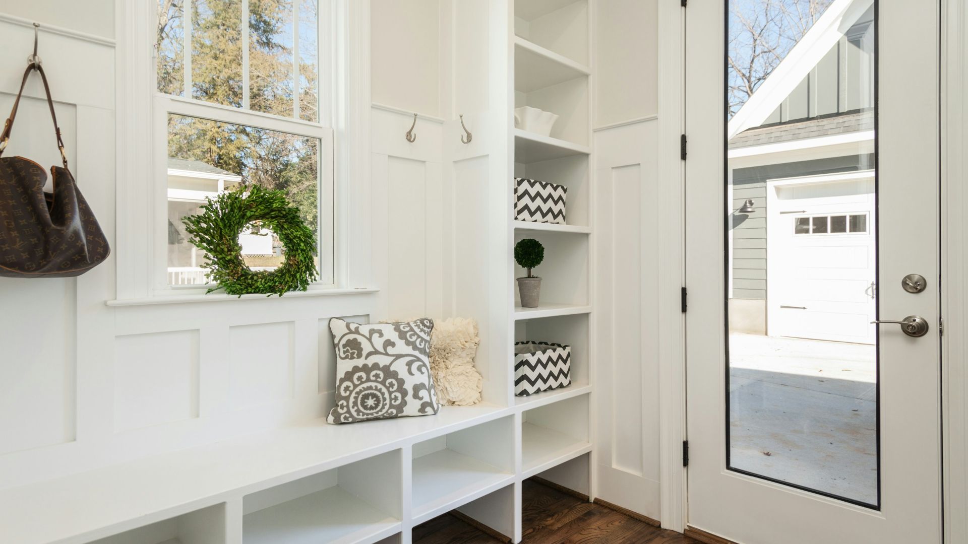gray and white floral throw pillow beside rack inside room