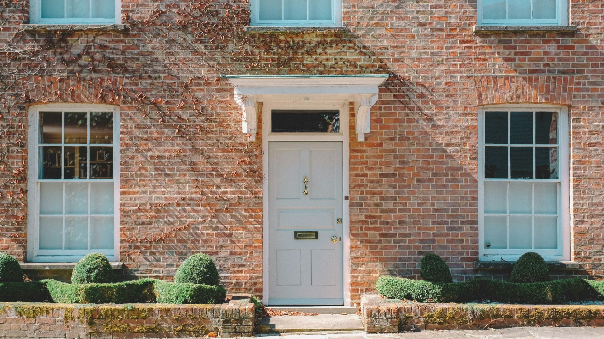 brown brick building with white wooden door