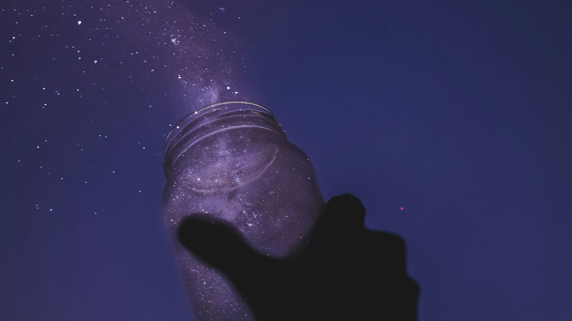 person holding glass jar