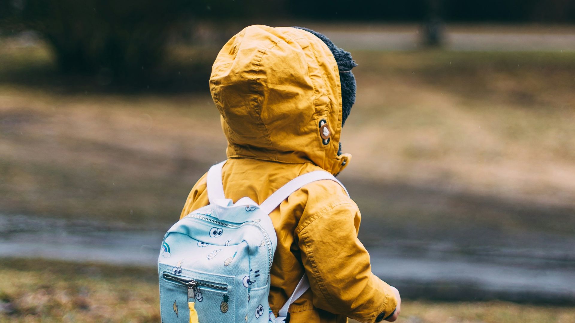 shallow focus photo of toddler walking near river