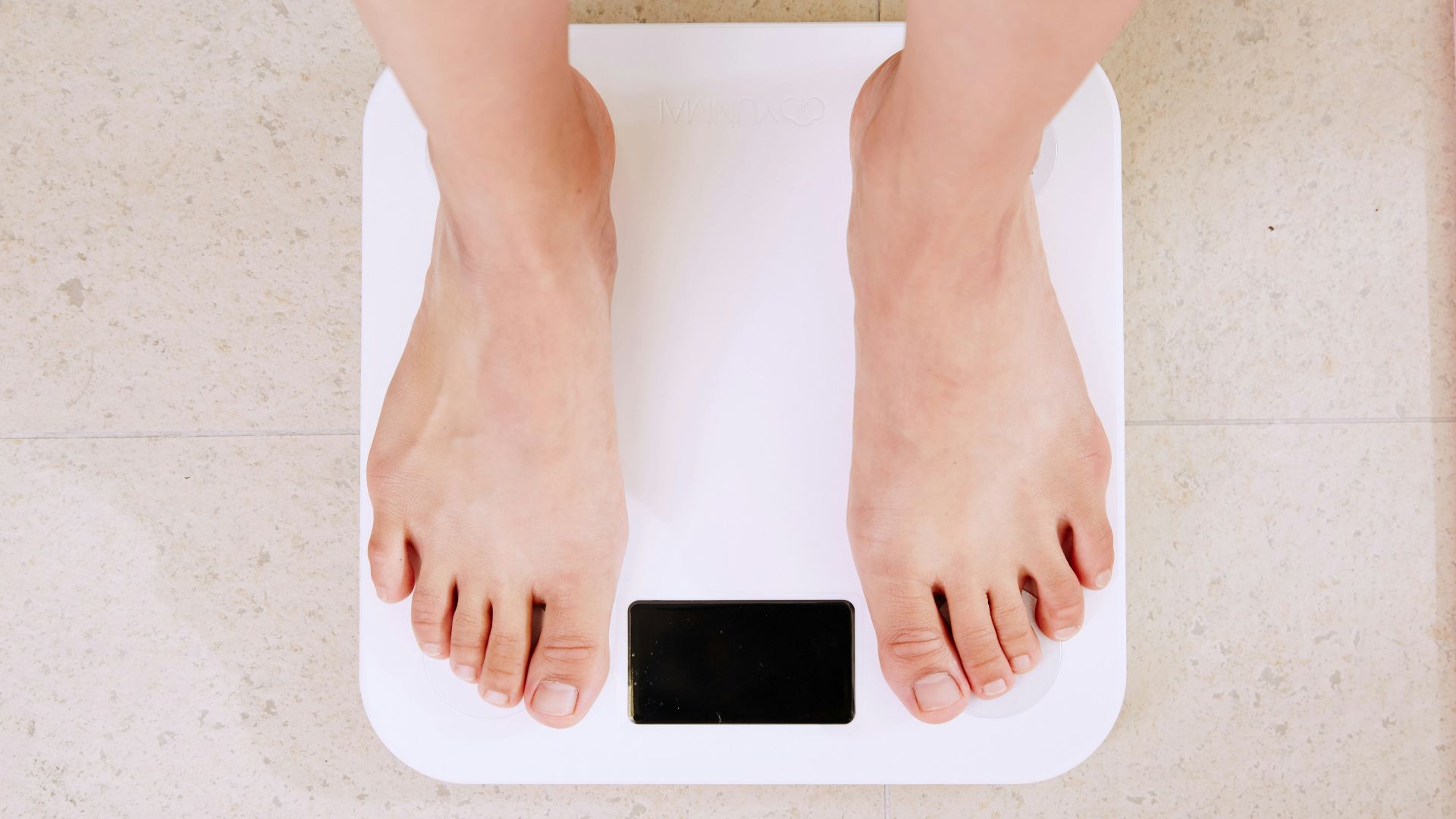 person standing on white digital bathroom scale