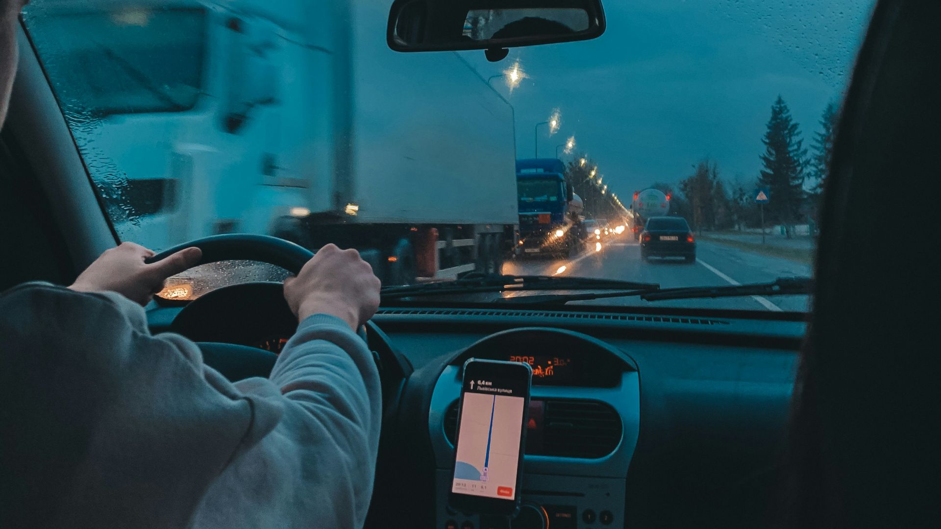 person in gray long sleeve shirt driving car