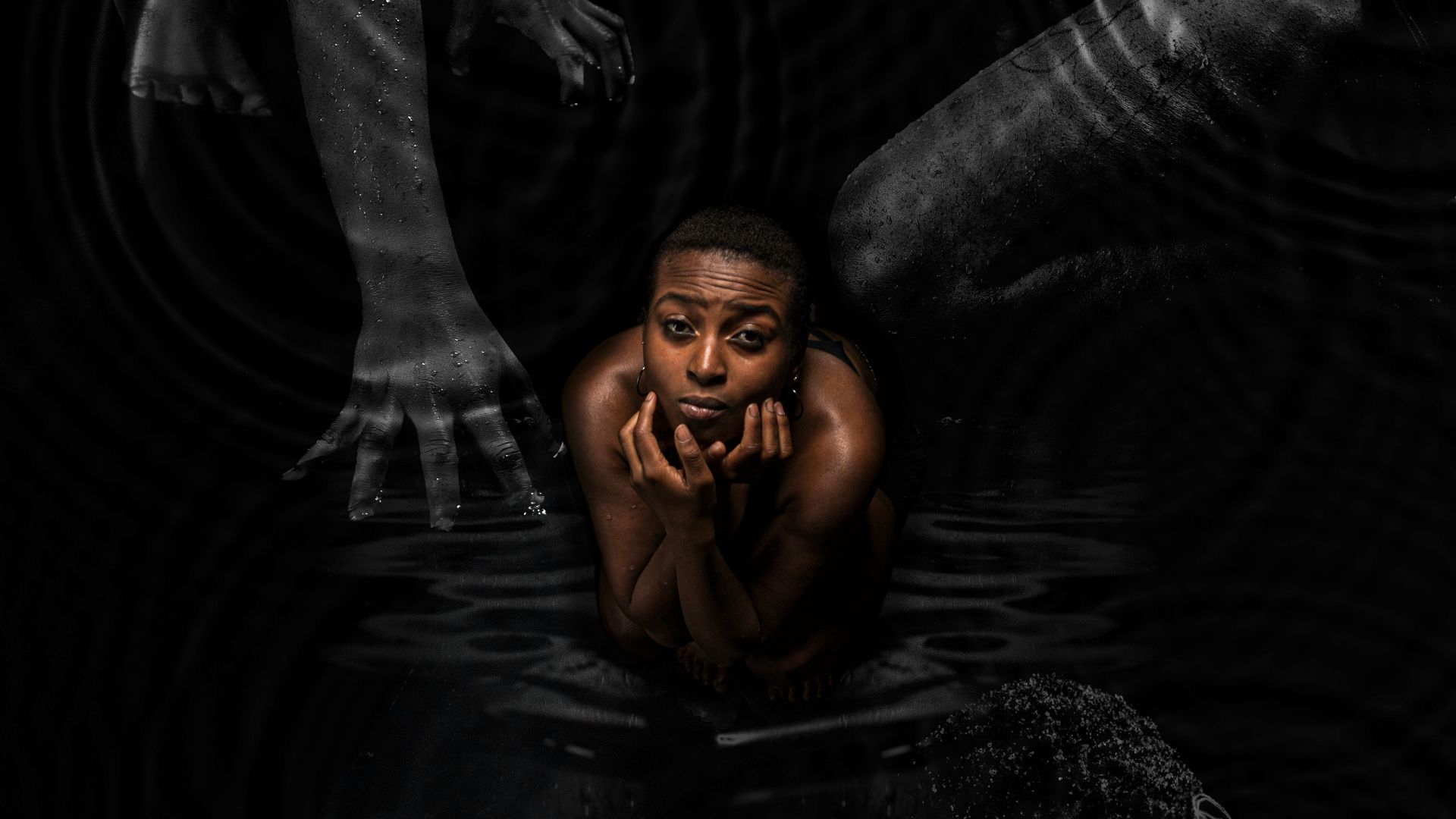 a man is floating in the water with his hands on his face