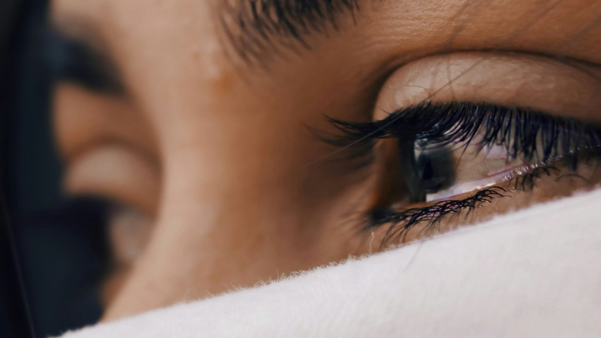 shallow focus of a woman's sad eyes