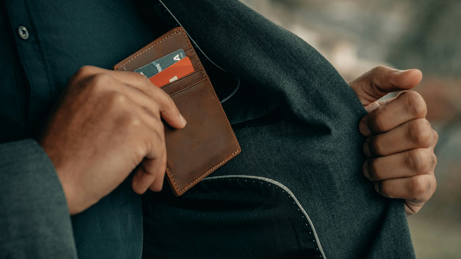 a man holding a wallet in his pocket