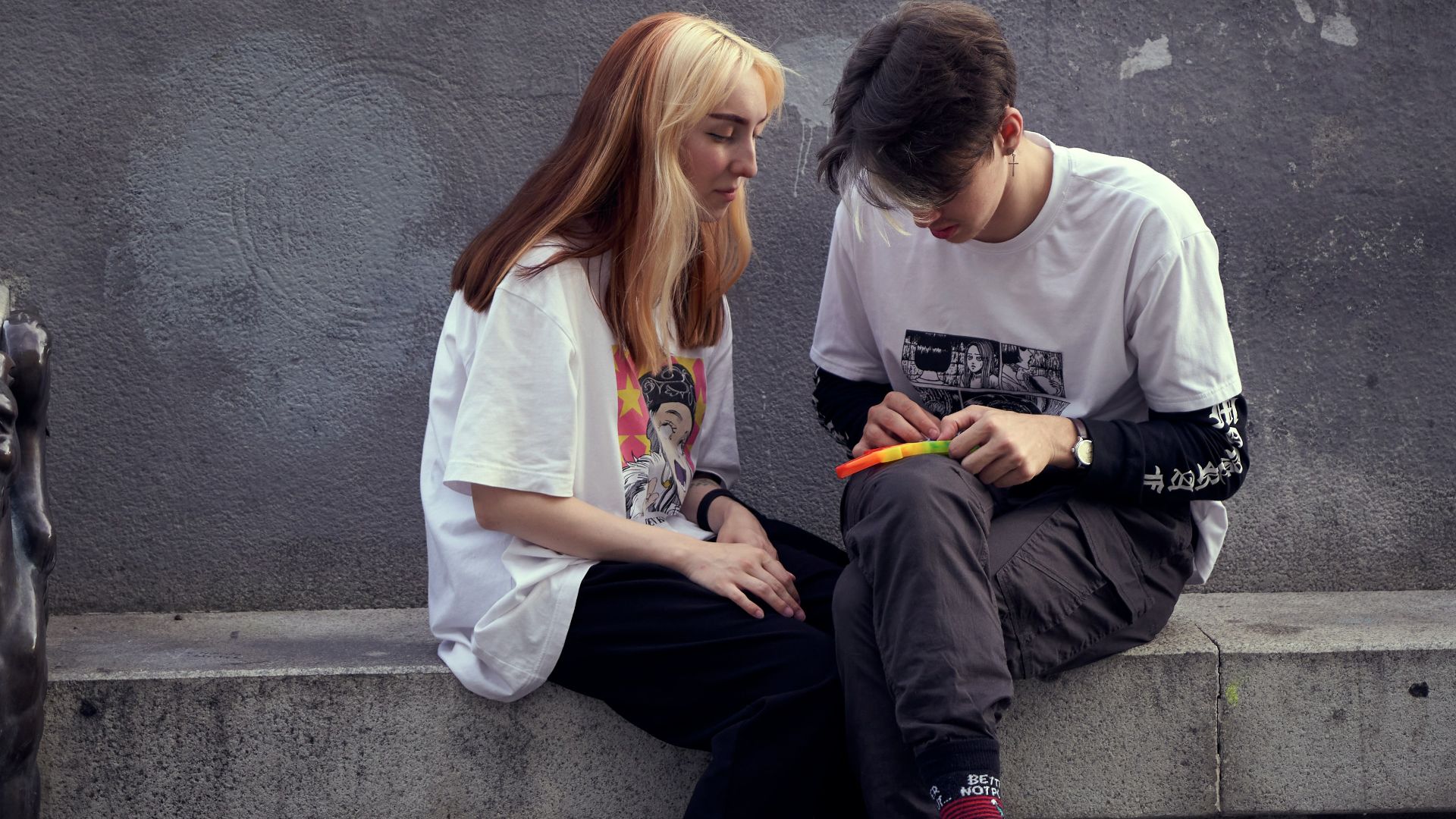 man in white crew neck t-shirt sitting beside woman in white crew neck t-shirt
