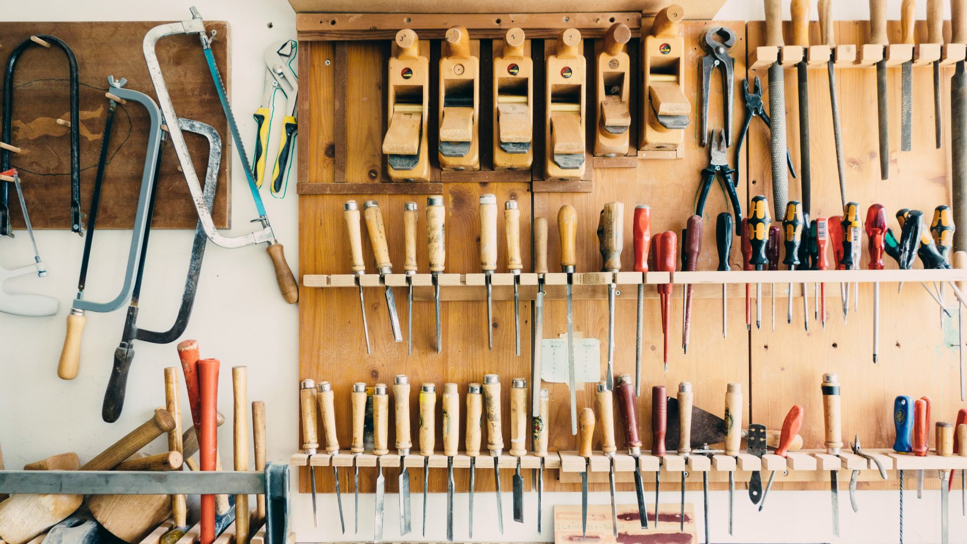 assorted handheld tools in tool rack