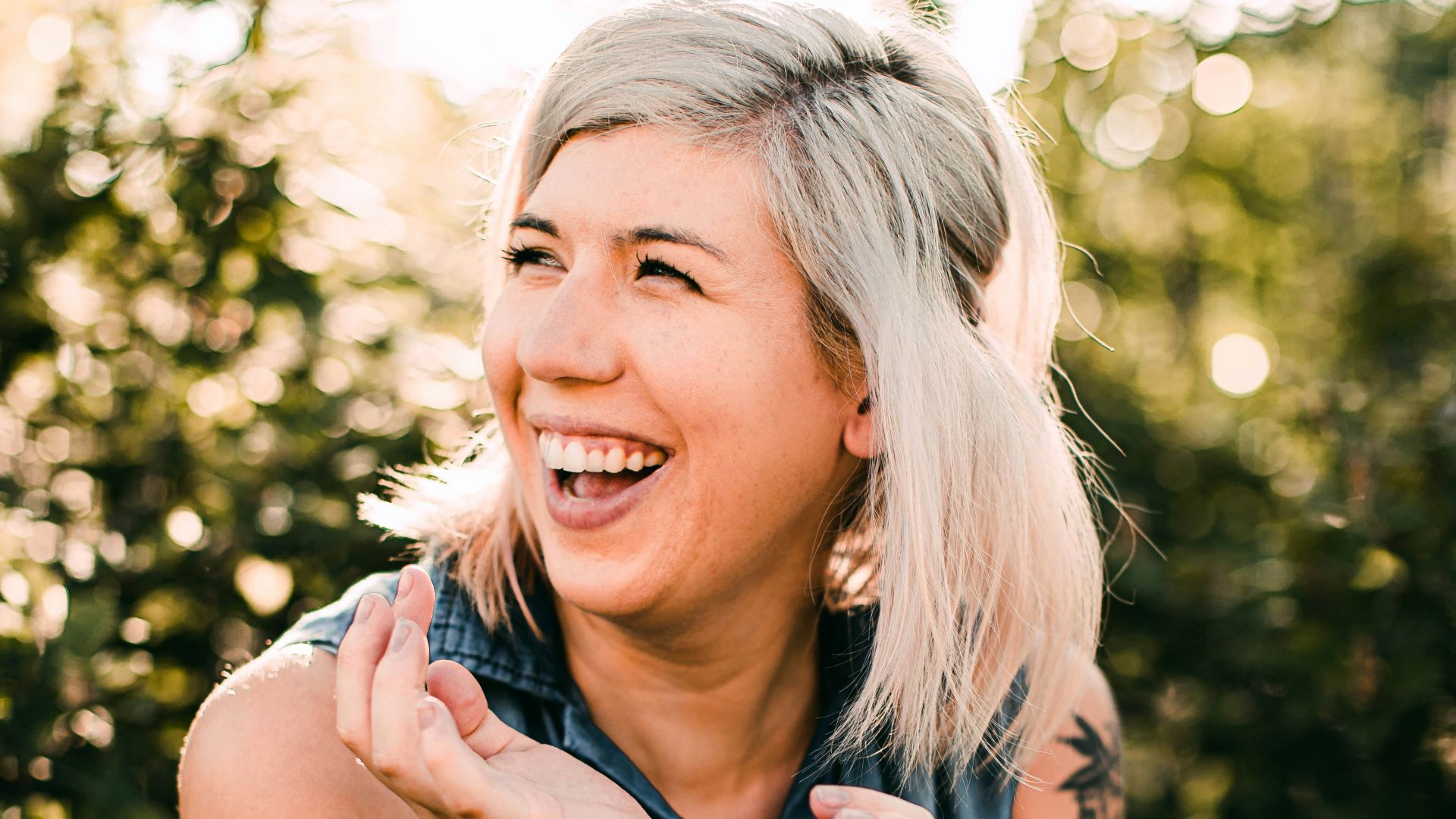 woman in black tank top smiling