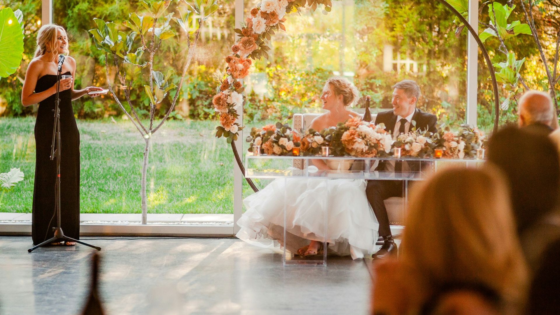 a woman standing at a podium in front of a crowd